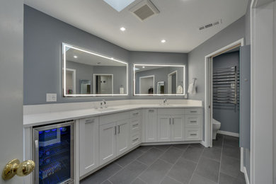 Example of a mid-sized minimalist master gray floor, double-sink and porcelain tile bathroom design in Portland with flat-panel cabinets, white cabinets, a drop-in sink, white countertops, a two-piece toilet, gray walls, quartzite countertops and a built-in vanity