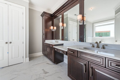 Bathroom - large transitional master gray tile, white tile and porcelain tile porcelain tile and white floor bathroom idea in Atlanta with raised-panel cabinets, medium tone wood cabinets, gray walls, an undermount sink, marble countertops and a hinged shower door