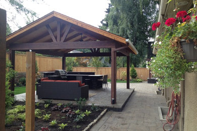 Design ideas for a transitional backyard partial sun garden in Portland with concrete pavers.