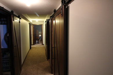 Example of a mid-sized farmhouse carpeted hallway design in Calgary with beige walls