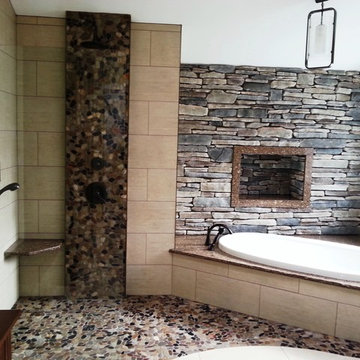 Ensuite bathroom with warm tones of brick and stone