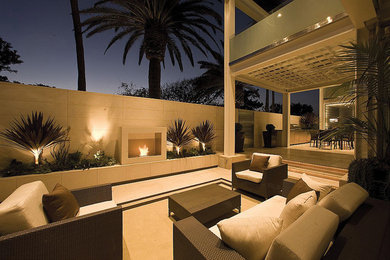 Example of a mid-sized beach style backyard tile patio design in Orange County with no cover