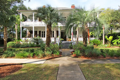 Large island style white two-story concrete fiberboard exterior home photo in Charleston with a hip roof