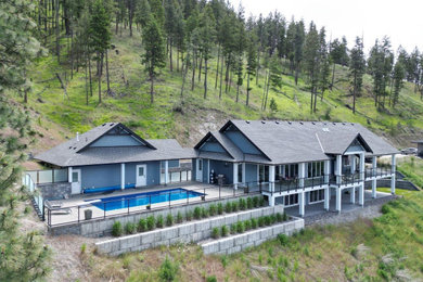 Example of a large arts and crafts blue one-story concrete fiberboard exterior home design in Other with a shingle roof and a gray roof