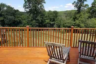 Mid-sized elegant backyard deck photo in New York with no cover