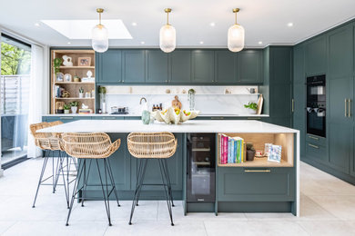 Design ideas for a classic kitchen in London with shaker cabinets, green cabinets, quartz worktops and an island.