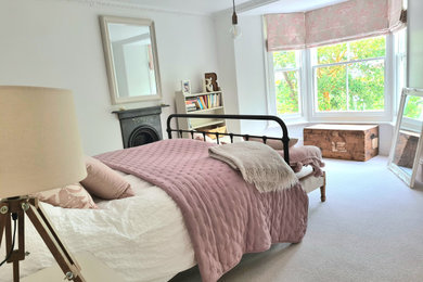 Photo of a large vintage guest bedroom in Cornwall with white walls, carpet and grey floors.