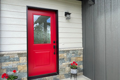 Entryway - mid-sized modern concrete floor entryway idea in Other with white walls and a red front door