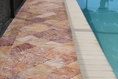 Inspiration for a mid-sized stone pool remodel in Tampa