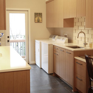 This is an example of a large contemporary galley separated utility room in Portland with a submerged sink, flat-panel cabinets, medium wood cabinets, engineered stone countertops, beige walls, porcelain flooring and a side by side washer and dryer.
