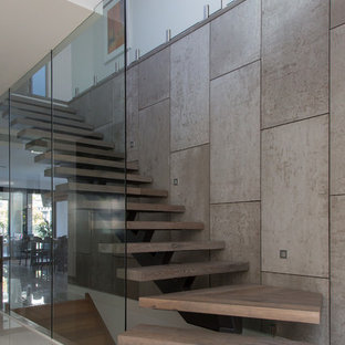 Design ideas for a medium sized contemporary wood wood railing staircase in Melbourne with glass risers.