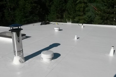 Design ideas for a house exterior in Vancouver with a flat roof.