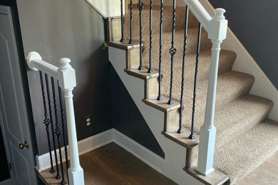Inspiration for a carpeted l-shaped wood railing staircase remodel in Kansas City