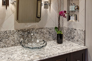 Bathroom - transitional beige tile and porcelain tile bathroom idea in Chicago with a vessel sink, furniture-like cabinets, dark wood cabinets, quartz countertops and a two-piece toilet