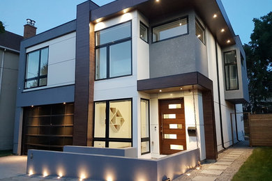 Example of a large trendy white two-story mixed siding exterior home design in Toronto