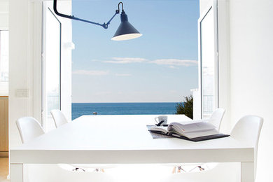 Inspiration for a small mediterranean open plan dining in Barcelona with white walls, ceramic floors and no fireplace.