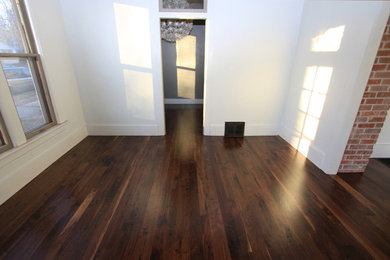 Example of an arts and crafts dark wood floor living room design in Boise with white walls