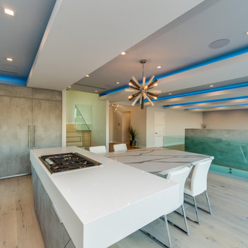 Concrete-Look Kitchen with Waterfall Marble Island and LED Cove