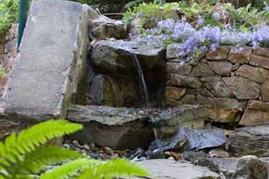 Design ideas for a small shade stone pond in Vancouver for summer.