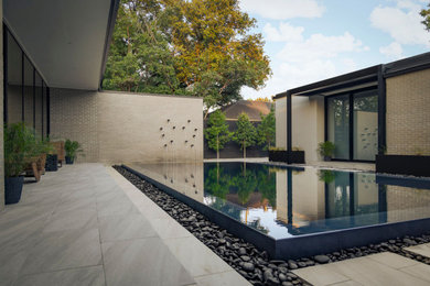 Pool - modern tile and rectangular pool idea in Dallas