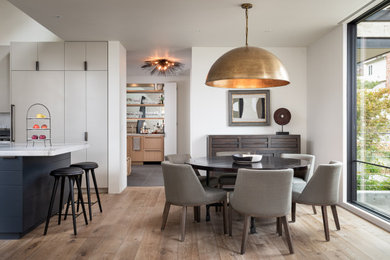 Great room - mid-sized contemporary medium tone wood floor and brown floor great room idea in Orange County with white walls and no fireplace