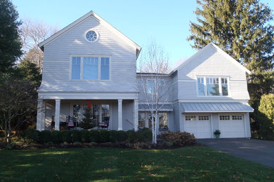 Inspiration for a mid-sized transitional gray two-story wood exterior home remodel in New York with a metal roof