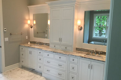 Inspiration for a large traditional master bathroom in Minneapolis with raised-panel cabinets, white cabinets, beige walls, an undermount sink and white floor.
