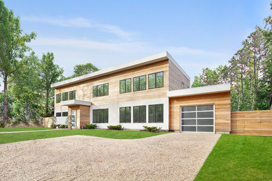 Large two-story wood exterior home idea in New York