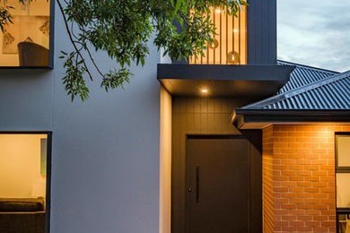 Photo of a beach style two-storey exterior in Canberra - Queanbeyan.