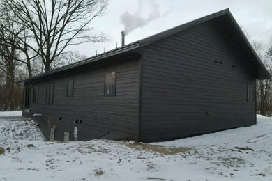 Inspiration for a mid-sized transitional black one-story wood gable roof remodel in Minneapolis