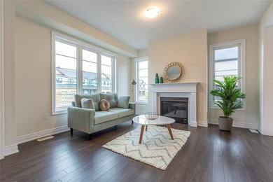 Living room - mid-sized mid-century modern open concept brown floor living room idea in Toronto with white walls, a standard fireplace, a wood fireplace surround and no tv