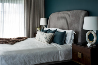 Example of a large trendy master dark wood floor and brown floor bedroom design in Toronto with blue walls and no fireplace