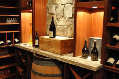 Wine cellar - mid-sized mediterranean concrete floor wine cellar idea in Portland