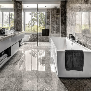 Idée de décoration pour une salle de bain design de taille moyenne avec un placard à porte vitrée, un lavabo encastré et un plan de toilette en granite.