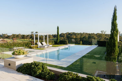 Inspiration for a large country backyard infinity pool in Sydney with with a pool.