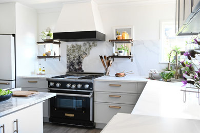 Mid-sized elegant l-shaped vinyl floor and gray floor eat-in kitchen photo in Vancouver with an undermount sink, shaker cabinets, gray cabinets, solid surface countertops, white backsplash, stone slab backsplash, black appliances, an island and white countertops