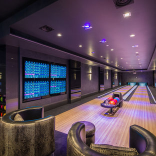 Imagen de sótano con puerta contemporáneo, grande, sin chimenea, con paredes grises, moqueta y suelo negro