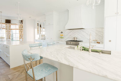 Large transitional medium tone wood floor eat-in kitchen photo in Atlanta with an undermount sink, shaker cabinets, white cabinets, marble countertops, white backsplash, marble backsplash, stainless steel appliances, two islands and white countertops
