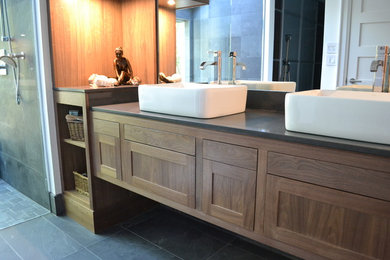 Large trendy bathroom photo in Toronto with dark wood cabinets, a vessel sink and quartz countertops