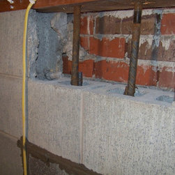 Foundation repair, retrofit by placing rebar and concrete in cores of block - Products