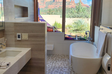 Large beach style master brown tile and stone tile light wood floor, brown floor, double-sink and vaulted ceiling bathroom photo in Phoenix with white cabinets, white walls, an undermount sink, marble countertops, white countertops and a floating vanity