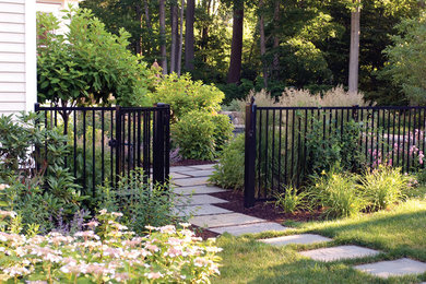 Inspiration for a traditional partial sun stone landscaping in New York.