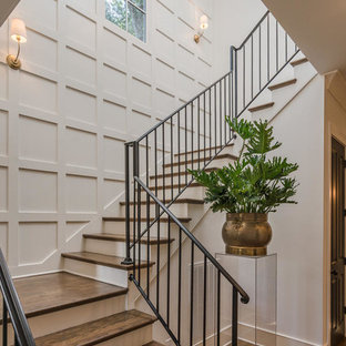 Traditional wood l-shaped metal railing staircase in Nashville with painted wood risers.