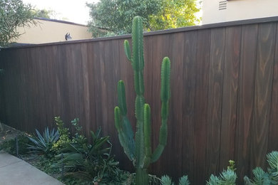 This is an example of a large contemporary drought-tolerant and partial sun backyard concrete paver landscaping in Los Angeles for summer.