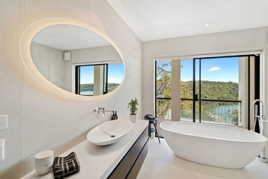 This is an example of a large contemporary bathroom in Sydney with porcelain tile, white walls, porcelain floors and white floor.