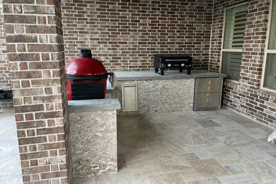 Example of an eclectic backyard patio kitchen design in Houston