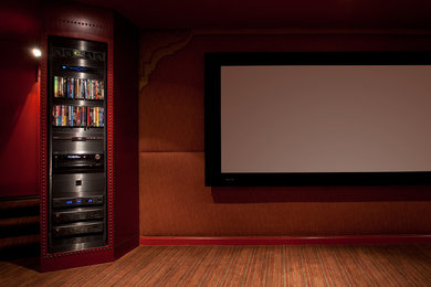 Large tuscan enclosed carpeted home theater photo in Los Angeles with a projector screen