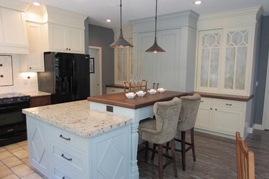 Kitchen - traditional kitchen idea in Minneapolis with black appliances and quartz countertops