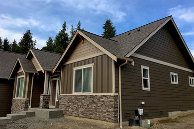Example of a mid-sized arts and crafts multicolored two-story mixed siding exterior home design in Seattle with a tile roof