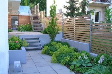 This is an example of a small contemporary shade side yard concrete paver landscaping in Other for summer.